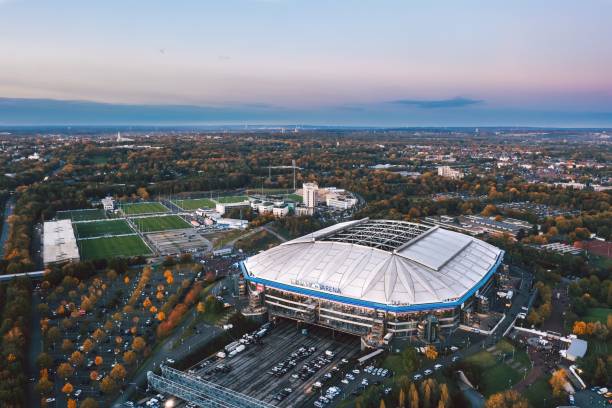 Gelsenkirchen, North Rhine-Westphalia, Germany - October 2021: Arial panoramic view on Veltins Arena (also known as Arena AufSchalke) at sunset, home stadium for Bundesliga team FC Schalke 04